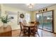 Bright dining room with wood table, chairs, and sliding glass doors at 9852 Zephyr Dr, Broomfield, CO 80021