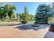 Beautiful exterior view showcasing lush landscaping, brick pavers, and a decorative fire pit feature at 9852 Zephyr Dr, Broomfield, CO 80021