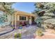 Charming front porch with stone accents, flowering plants, and seating at 9852 Zephyr Dr, Broomfield, CO 80021