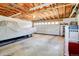 Spacious garage with unfinished ceiling and a large covered truck or car at 9852 Zephyr Dr, Broomfield, CO 80021