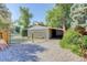 Gray barn with green metal gate and gravel driveway at 9852 Zephyr Dr, Broomfield, CO 80021