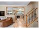 Inviting living room view into the kitchen, featuring wood floors and staircase at 9852 Zephyr Dr, Broomfield, CO 80021