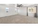 Expansive bedroom with neutral carpet, multiple windows, a ceiling fan, and great natural light at 1405 Willow Oak Rd, Castle Rock, CO 80104