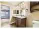 Well-lit bathroom features a vanity, countertop, and adjacent bedroom view at 9023 Apache Plume Dr # D, Parker, CO 80134