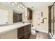 Bathroom featuring a vanity, long mirror, toilet, and glass enclosed shower at 9023 Apache Plume Dr # D, Parker, CO 80134