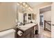 Bathroom with large countertop, mirror, vanity lighting, and tiled floor at 9023 Apache Plume Dr # D, Parker, CO 80134