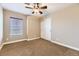 Standard bedroom with neutral walls, carpet, window with blinds, and a closet at 9023 Apache Plume Dr # D, Parker, CO 80134
