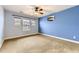 Minimalist bedroom featuring carpeted floors, windows for natural light, and soothing wall colors at 9023 Apache Plume Dr # D, Parker, CO 80134