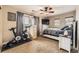 Bedroom featuring ceiling fan, exercise bike, comfortable bed, and natural light at 9023 Apache Plume Dr # D, Parker, CO 80134
