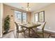 Cozy dining room featuring a square table set for a meal and natural light from a sliding door at 9023 Apache Plume Dr # D, Parker, CO 80134