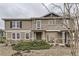 Attractive townhouse featuring tan siding, stone accents, and tidy landscaping on an overcast day at 9023 Apache Plume Dr # D, Parker, CO 80134