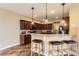 Charming kitchen with rich wood cabinets, bar seating, and stylish pendant lighting at 9023 Apache Plume Dr # D, Parker, CO 80134