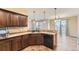 Well-equipped kitchen featuring dark wood cabinets and modern appliances at 9023 Apache Plume Dr # D, Parker, CO 80134