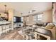 Spacious living room featuring a large TV, tile floors, and a cozy seating area at 9023 Apache Plume Dr # D, Parker, CO 80134