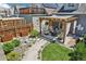 Landscaped backyard features a pergola-covered patio with comfortable seating and manicured gardens at 3207 N Marion St, Denver, CO 80205