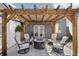 Cozy backyard patio with pergola, comfortable seating around a fire pit, perfect for relaxing outdoors at 3207 N Marion St, Denver, CO 80205