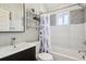 Stylish bathroom features a modern vanity, bathtub with shower, and decorative shelving at 3207 N Marion St, Denver, CO 80205