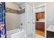 Modern bathroom featuring tile accents, bathtub, and a door leading to the kitchen at 3207 N Marion St, Denver, CO 80205