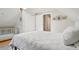 Bright bedroom features a crib, closet, sloped ceiling, neutral decor, and wood floors at 3207 N Marion St, Denver, CO 80205