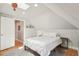 Bright bedroom with a sloped ceiling, white bedding, skylight, and hardwood floors at 3207 N Marion St, Denver, CO 80205