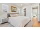 A serene bedroom showcasing a closet and connecting hallway with a hardwood floor at 3207 N Marion St, Denver, CO 80205