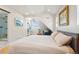 A bright bedroom with sitting area, desk, ensuite bathroom, and attractive decor at 3207 N Marion St, Denver, CO 80205