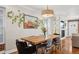 Light-filled dining room with hardwood floors, modern lighting, and easy access to living area at 3207 N Marion St, Denver, CO 80205