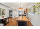 Bright dining room features a large wood table with hardwood floors and open access to other living spaces at 3207 N Marion St, Denver, CO 80205