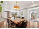 Open-concept dining room features a large wood table, hardwood floors and is filled with natural light at 3207 N Marion St, Denver, CO 80205