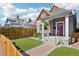 Well-maintained home boasts a tidy front yard with fresh green turf, enhanced by a wooden fence at 3207 N Marion St, Denver, CO 80205