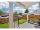 Covered front porch overlooking a fenced yard with newly installed artificial turf at 3207 N Marion St, Denver, CO 80205