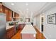 Bright kitchen features stainless steel appliances, wood cabinets, and a large island with breakfast bar at 3207 N Marion St, Denver, CO 80205