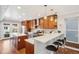 Modern kitchen with stainless steel appliances, an island with seating, and a neutral backsplash at 3207 N Marion St, Denver, CO 80205