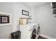Functional laundry room with modern washer and dryer, wicker basket, and neutral decor at 3207 N Marion St, Denver, CO 80205