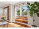 Sunlit room with exposed brick wall, a large picture window and hardwood flooring at 3207 N Marion St, Denver, CO 80205