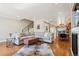 Open-concept room with hardwood floors, a fireplace, and view of the dining area at 3207 N Marion St, Denver, CO 80205
