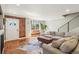 Inviting living room with natural light, exposed brick, hardwood floors, and cozy seating at 3207 N Marion St, Denver, CO 80205