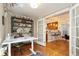 Bright office space with built-in shelving, a modern desk, and a view into the stylish kitchen at 3207 N Marion St, Denver, CO 80205