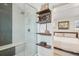 Tastefully designed shower with convenient seating, rain shower, and wall shelving with decor at 3207 N Marion St, Denver, CO 80205