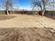 Large backyard featuring a wood fence and mature trees at 16841 E Mansfield Cir, Aurora, CO 80013