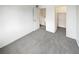 Clean bedroom showcasing neutral carpeting, closet, and ample natural light at 16841 E Mansfield Cir, Aurora, CO 80013