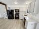 Modern kitchen with white cabinets, stainless steel appliances, and wood-look flooring at 16841 E Mansfield Cir, Aurora, CO 80013