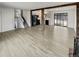 Open-concept living room with a staircase, modern kitchen, and sliding glass doors at 16841 E Mansfield Cir, Aurora, CO 80013