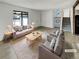 Bright and airy living room featuring neutral tones, stylish furniture, and large windows at 16841 E Mansfield Cir, Aurora, CO 80013