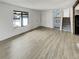 Minimalist living room with wood-look floors, large windows, and a staircase at 16841 E Mansfield Cir, Aurora, CO 80013