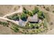 An aerial view of an estate featuring a large home, driveway, mature trees, and surrounding land at 8853 N Awl Rd, Parker, CO 80138
