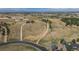 A panoramic aerial shot shows a vast field spotted with houses with mountains on the horizon at 8853 N Awl Rd, Parker, CO 80138