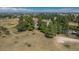 Expansive aerial view of the property nestled among trees with a picnic area and fire pit at 8853 N Awl Rd, Parker, CO 80138