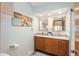 Bathroom featuring double sinks, decorative mirrors, and stylish accent lighting at 8853 N Awl Rd, Parker, CO 80138