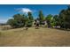Home with lush green lawn and mature trees under a blue sky at 8853 N Awl Rd, Parker, CO 80138